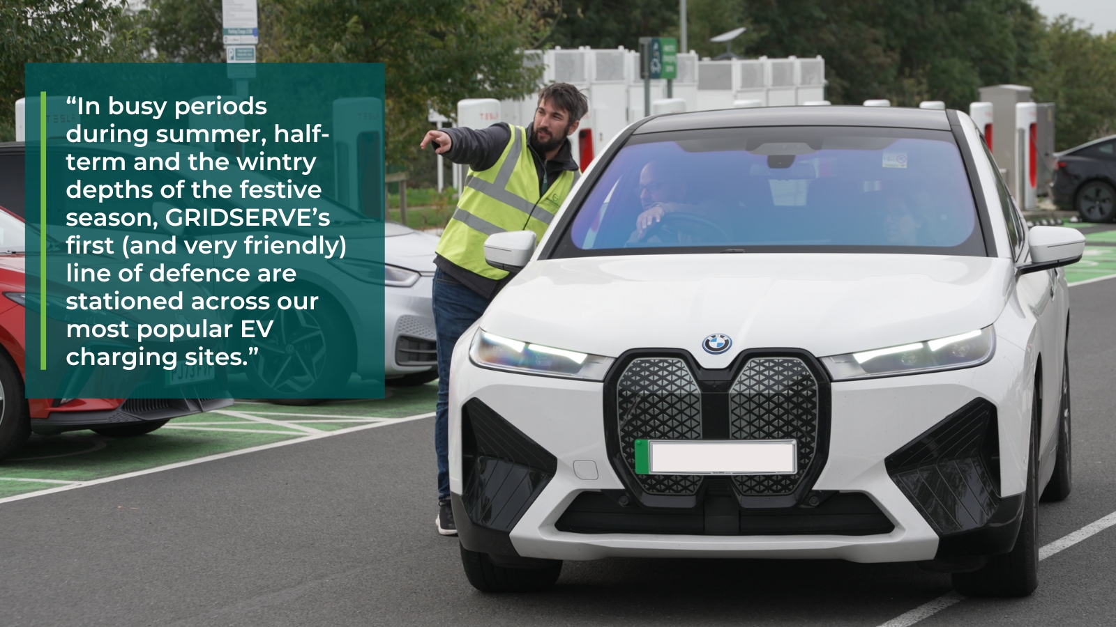 EV charging attendant for GRIDSERVE helping manage queues at an Electric Super Hub