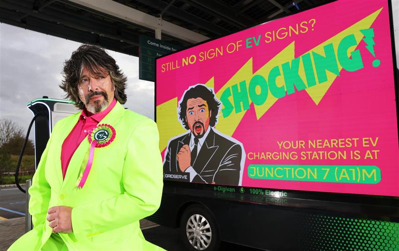 Laurence Llewelyn-Bowen stands in front of digital electric ad van